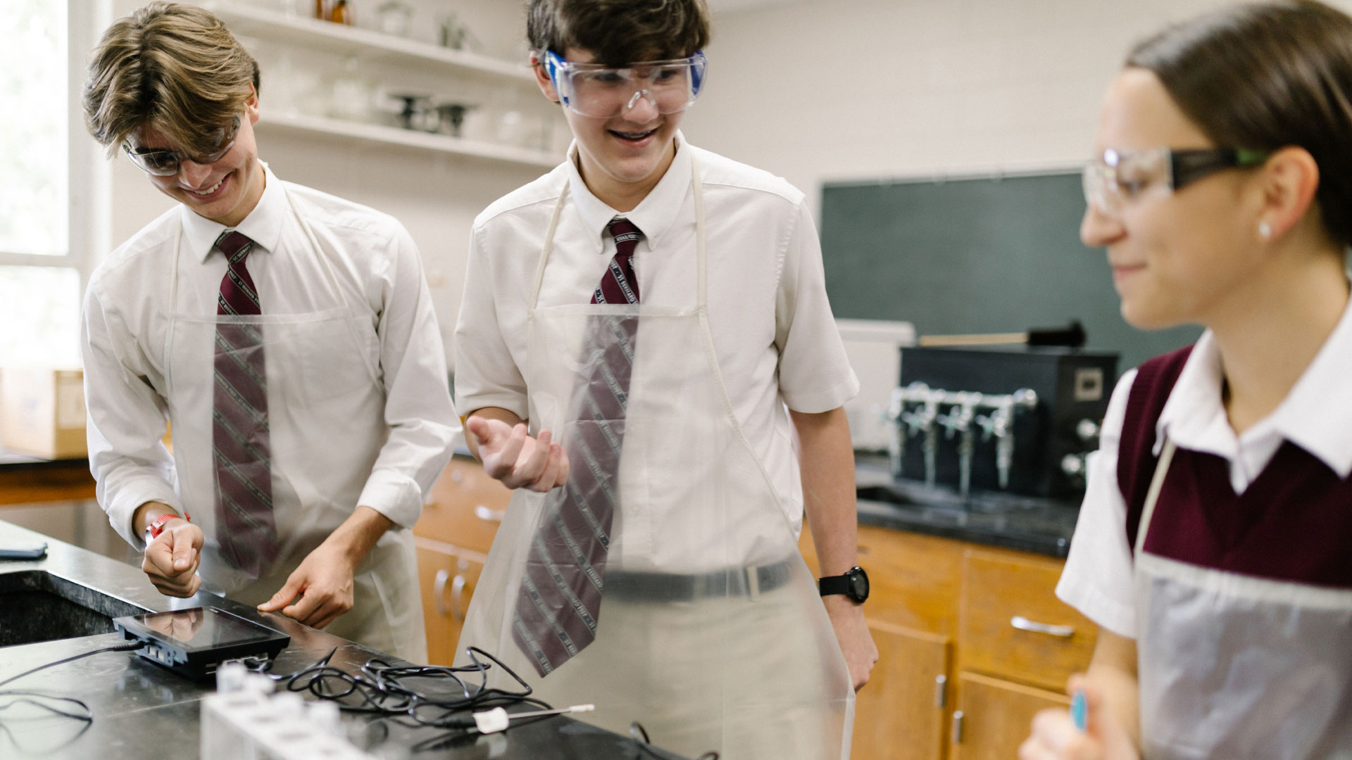 Best boarding schools in the US. Students at St Bernard, working together with Lab Quest in science class.